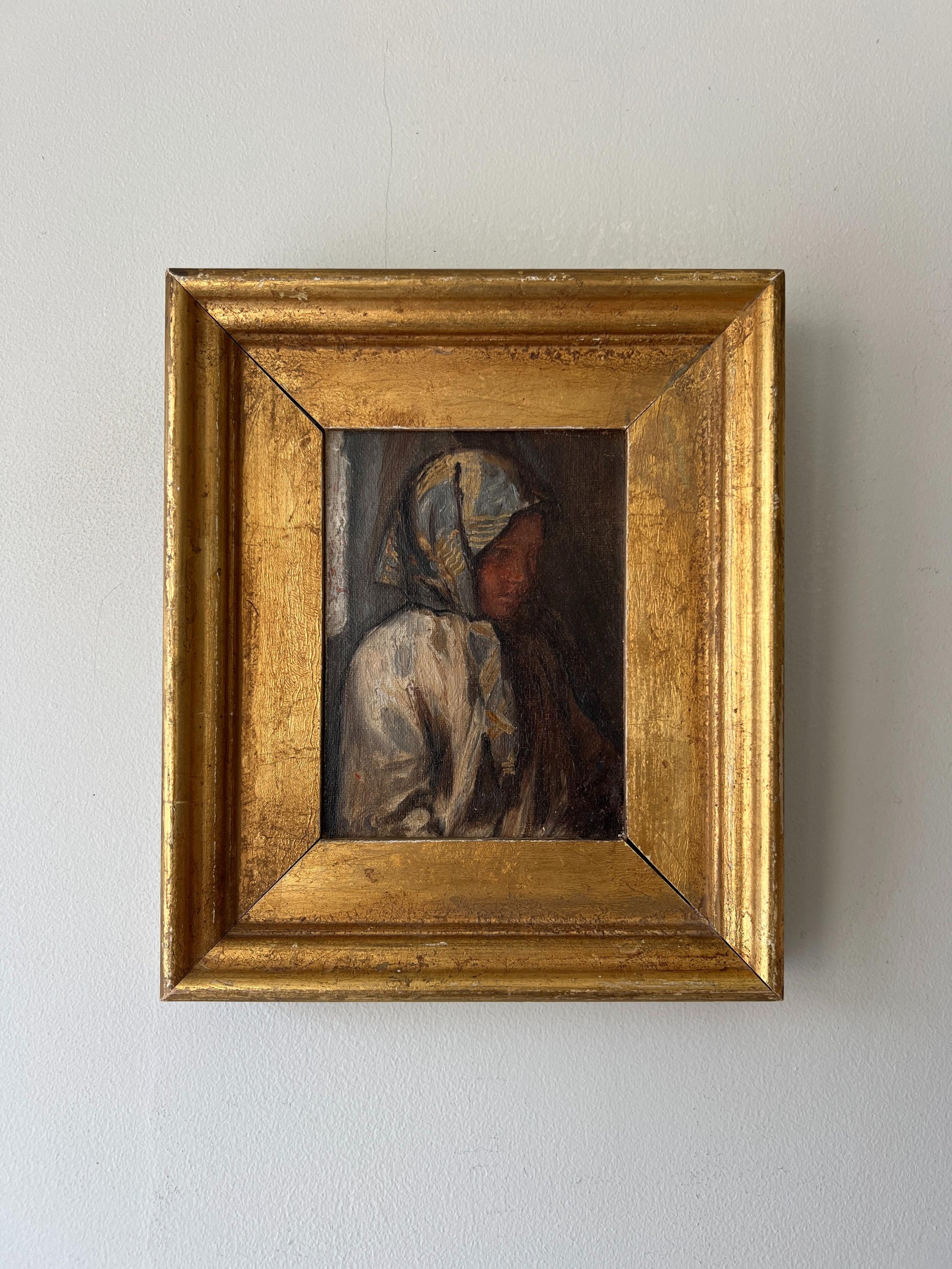 Small framed vintage oil painting of a female figure in a headscarf with a wide gilt frame. Available at Hue.