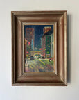 Framed vintage oil painting of a city street at night with cars and buildings. Available at Hue. 