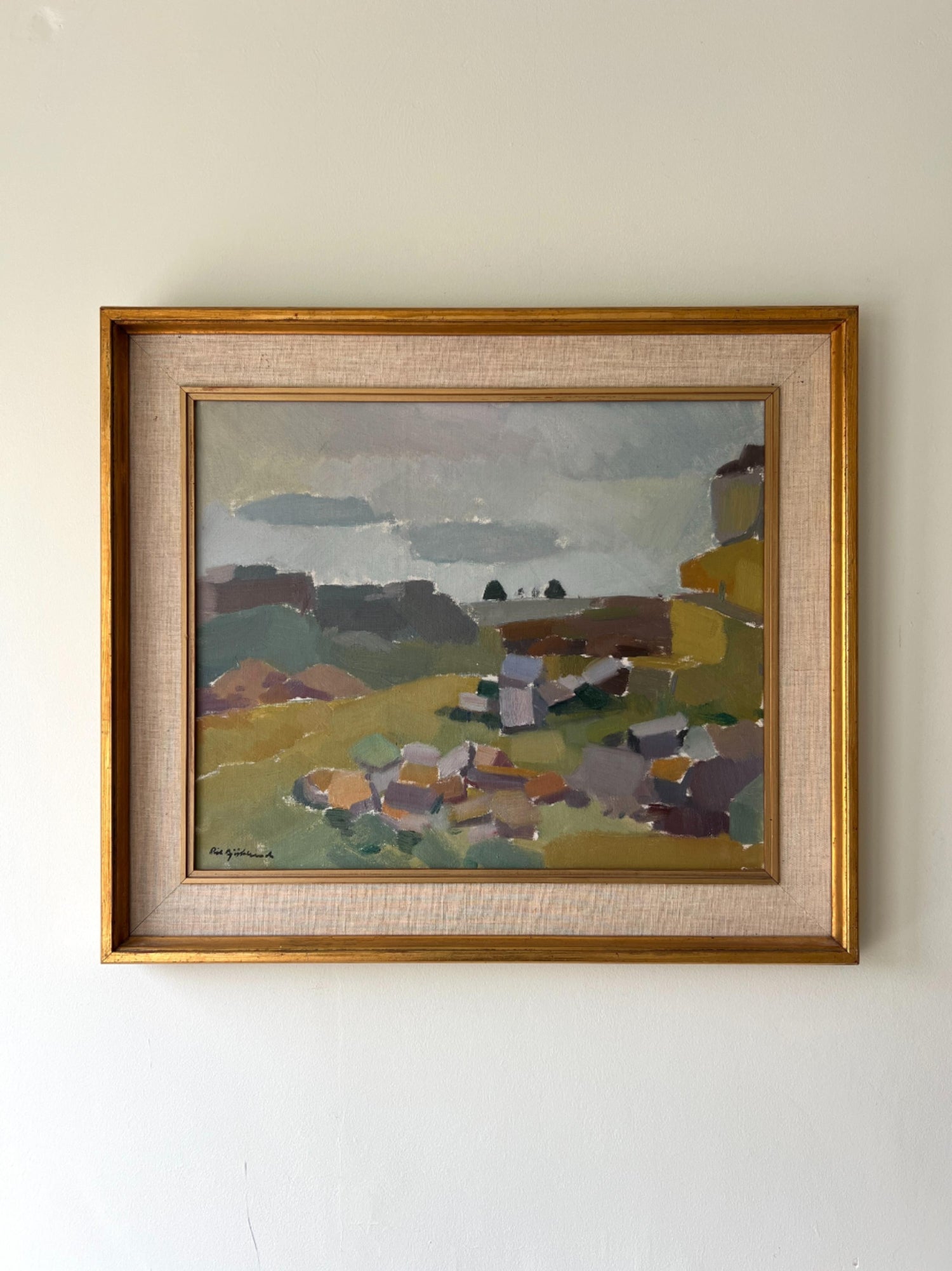 Framed painting of a landscape with muted palette of a rocky scene on a white wall available from hue