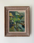 Framed vintage oil painting of hillside houses and trees. Available at Hue. 