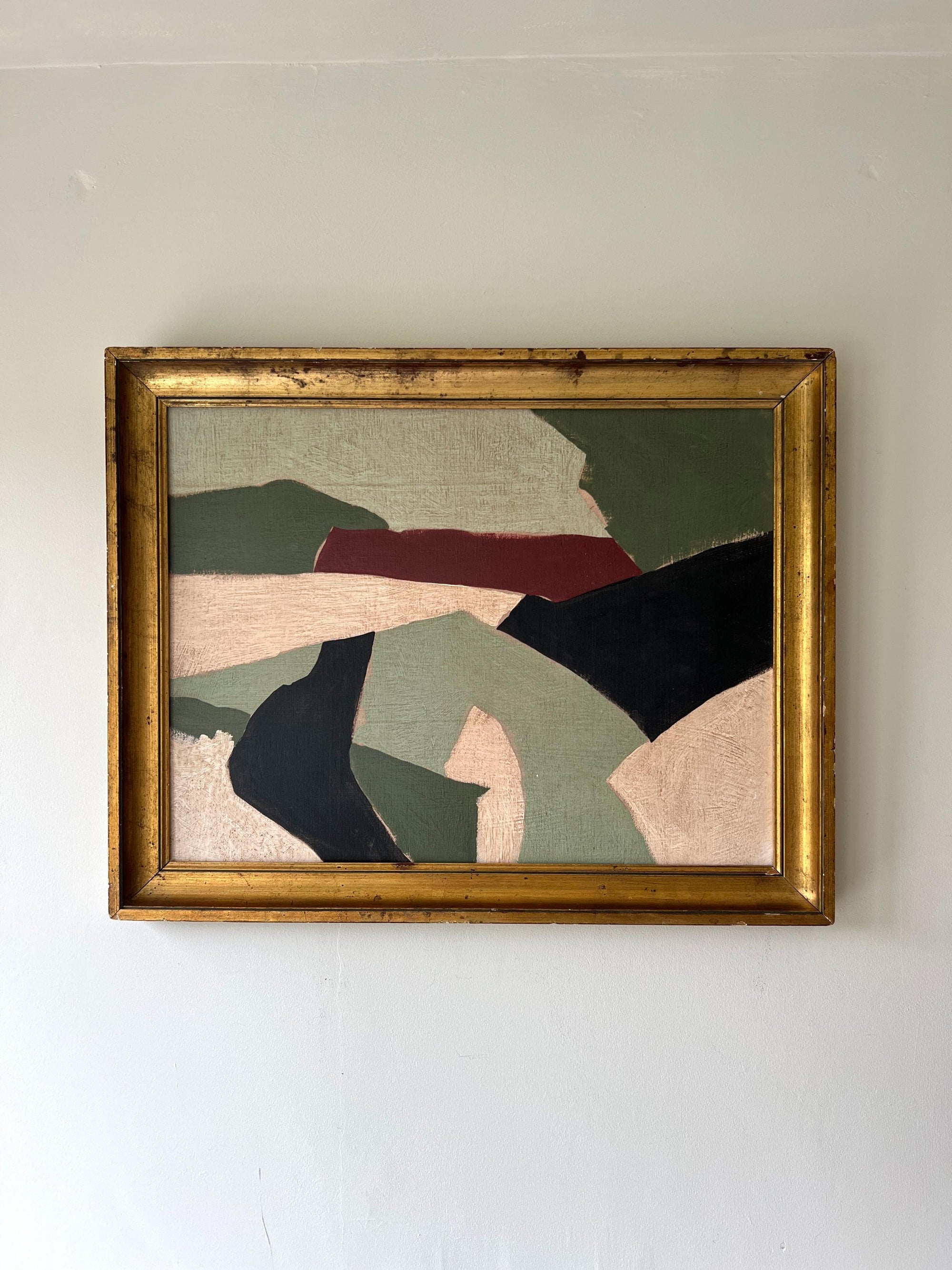 A contemporary abstract artwork of a geometric landscape framed in a vintage, gilt frame. Available at Hue. 