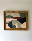 A contemporary abstract artwork of a geometric landscape framed in a vintage, gilt frame. Available at Hue. 