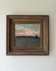 A framed landscape oil painting of a vineyard under an evening sky. Available at Hue. 