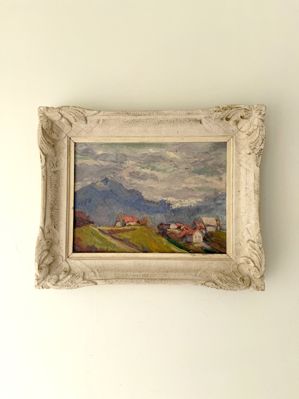 Framed vintage oil  painting of a landscape with mountains and village houses. Available at Hue. 
