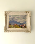 Framed vintage oil  painting of a landscape with mountains and village houses. Available at Hue. 