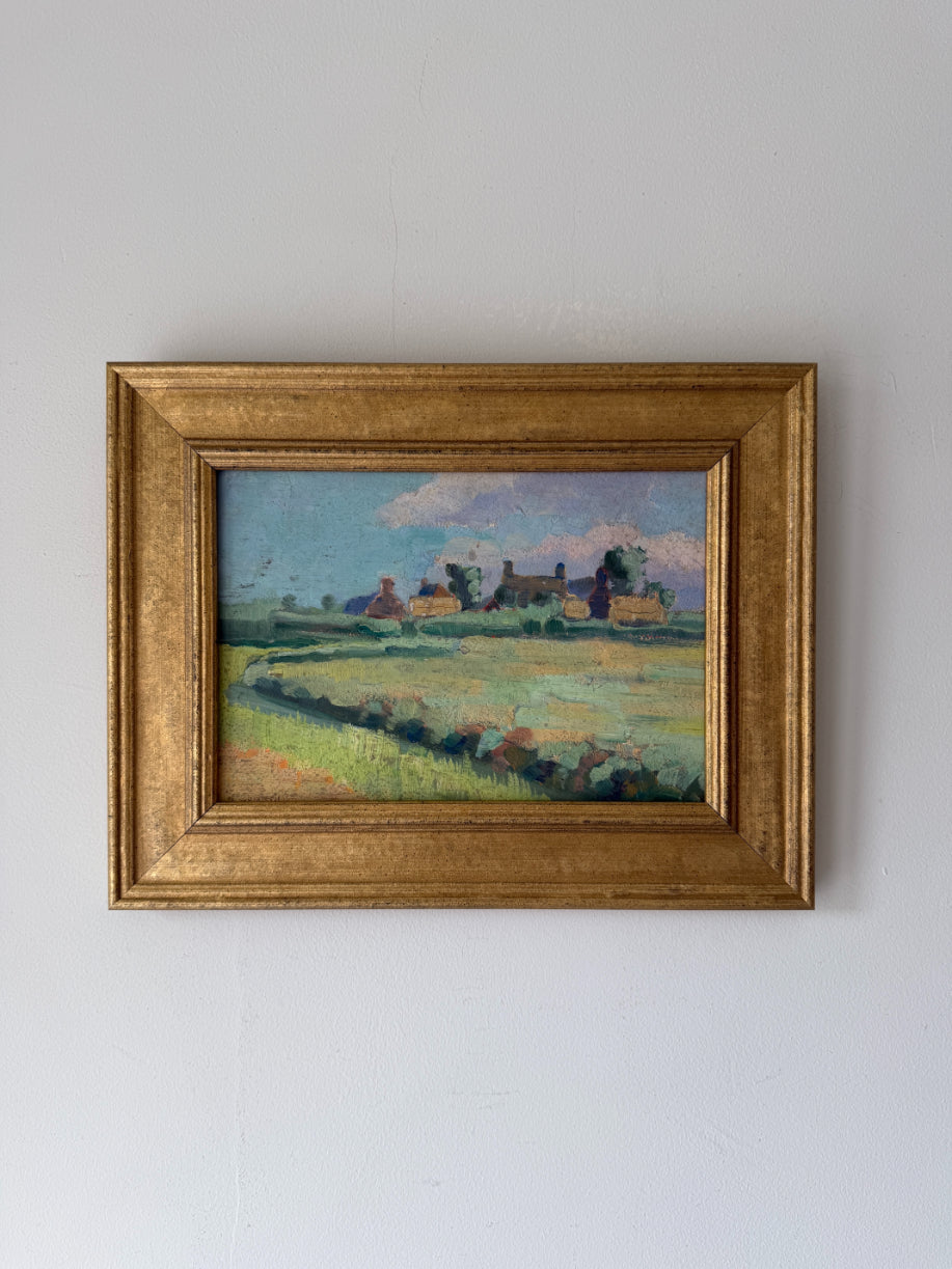 Framed vintage oil painting of a landscape with buildings. Available at Hue.