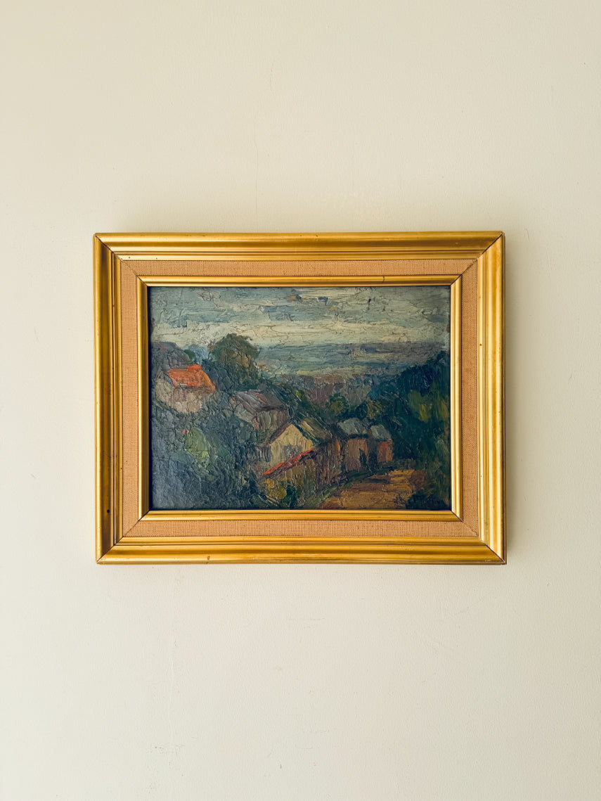 Framed vintage oil painting of a landscape with village houses. Available at Hue.
