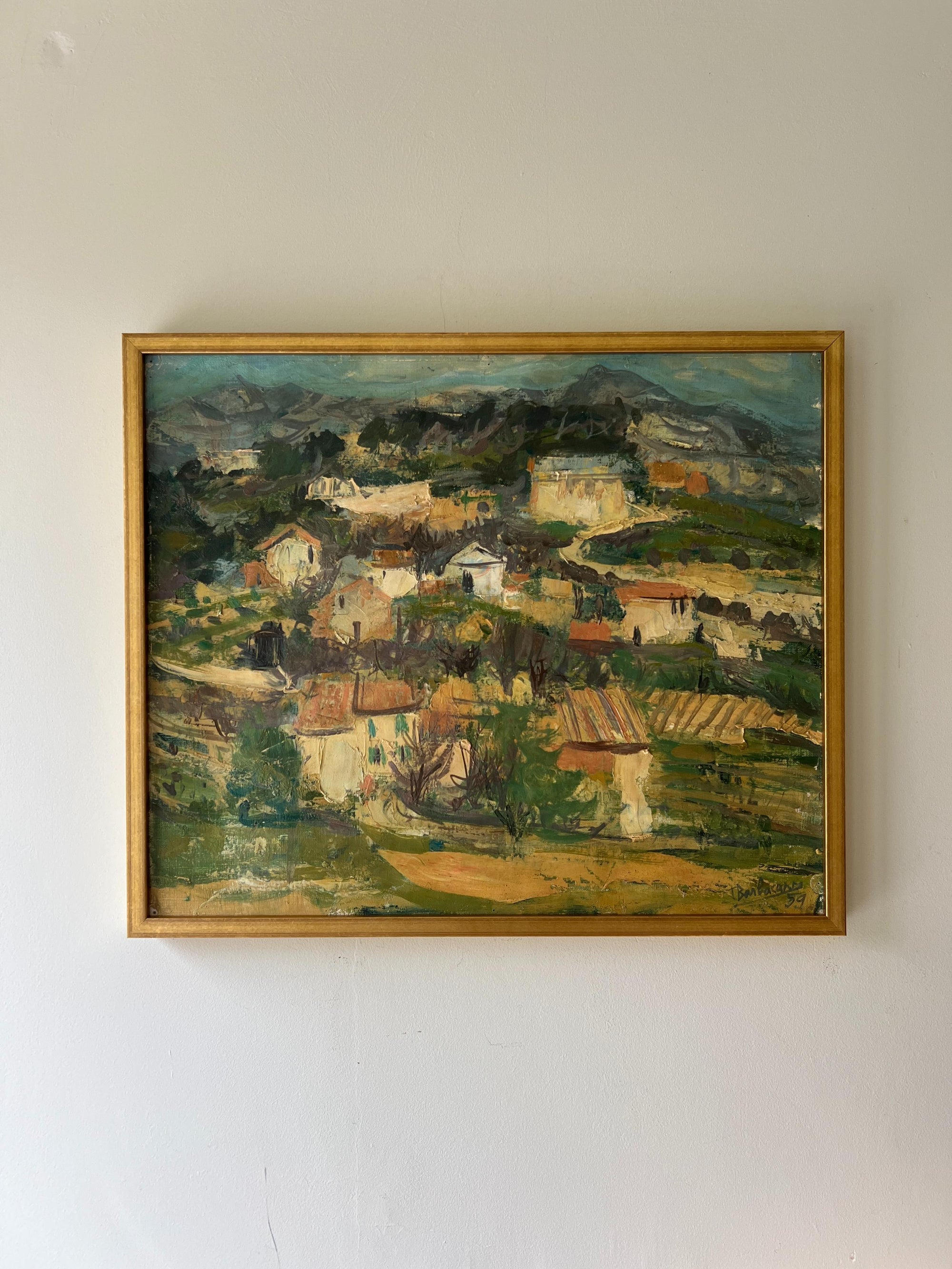 A framed vintage oil painting of an expressive landscape scene with a village in the hills. Available at Hue. 