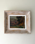 Framed vintage oil painting of a landscape with trees and a distant village. Available at Hue. 