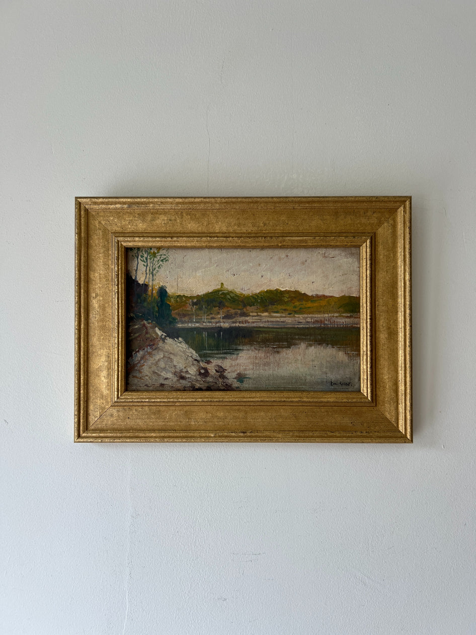 Small framed vintage oil painting of a lakeside landscape. Available at Hue. 