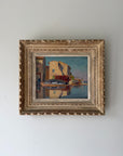 Ornately framed vintage oil painting of a harbour scene. Available at Hue. 