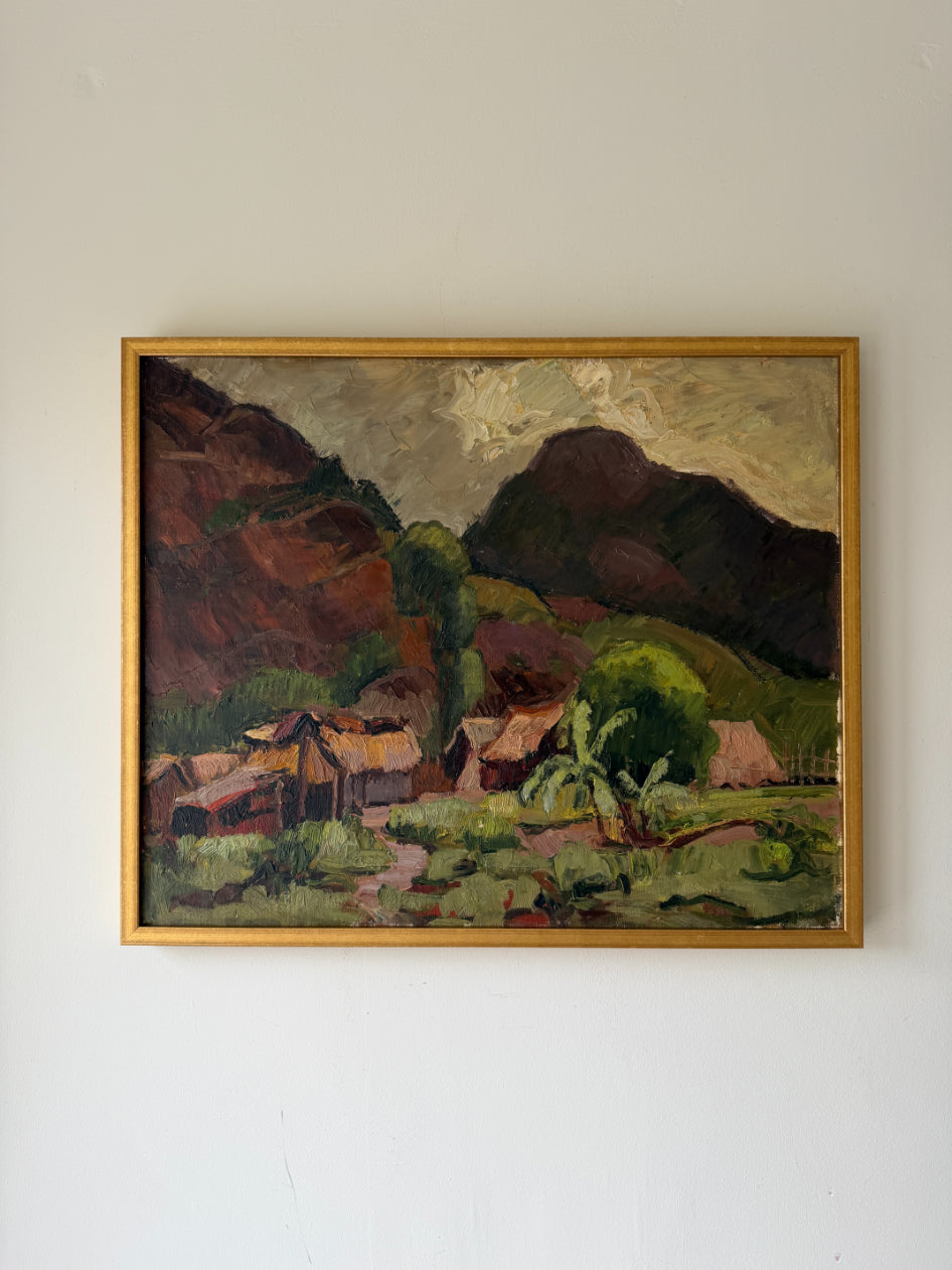 Framed vintage oil  painting of a landscape with mountains and village huts. Available at Hue. 