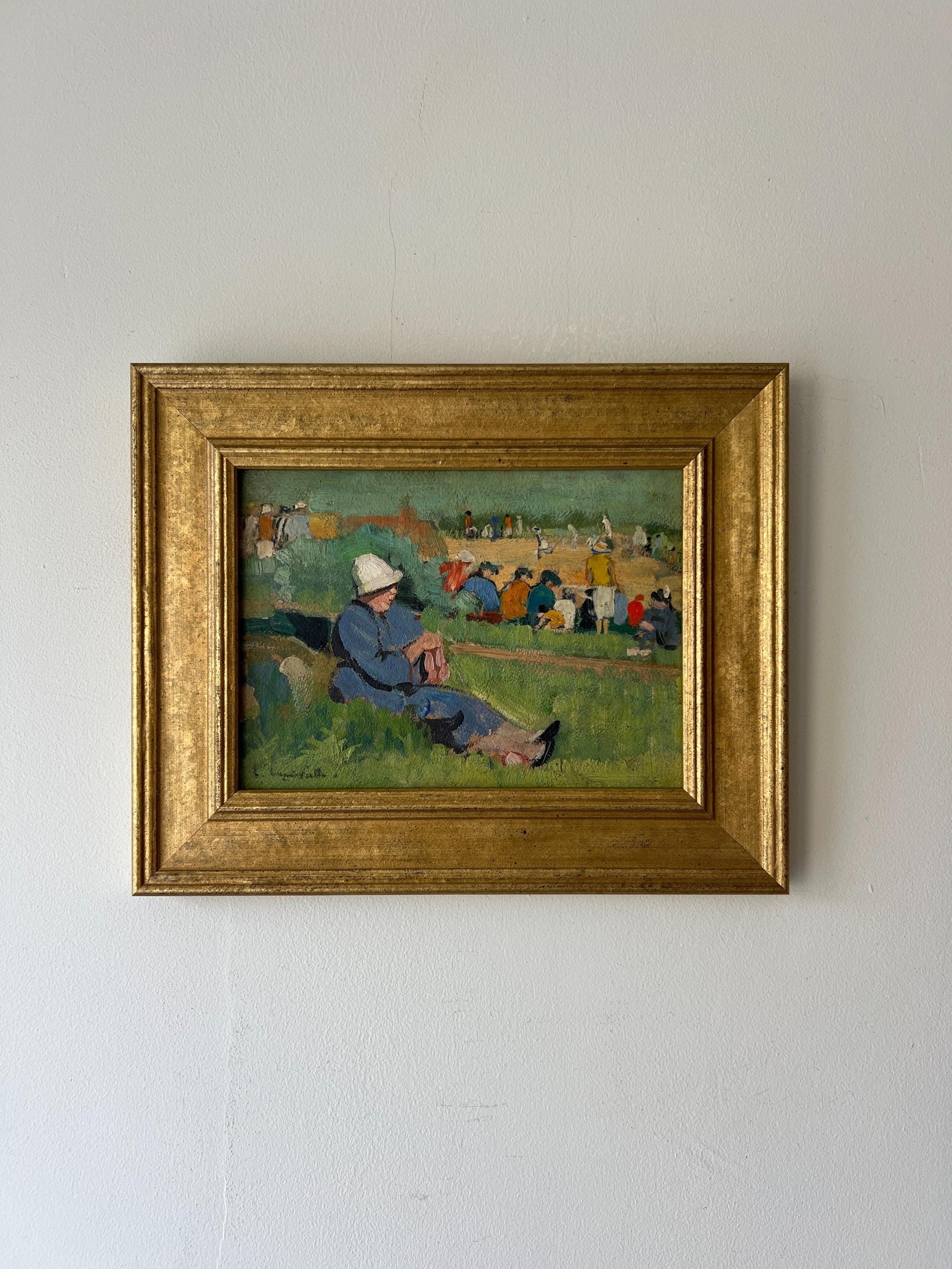 Framed vintage oil painting of a woman sitting on grass at a public gathering. Available at Hue. 
