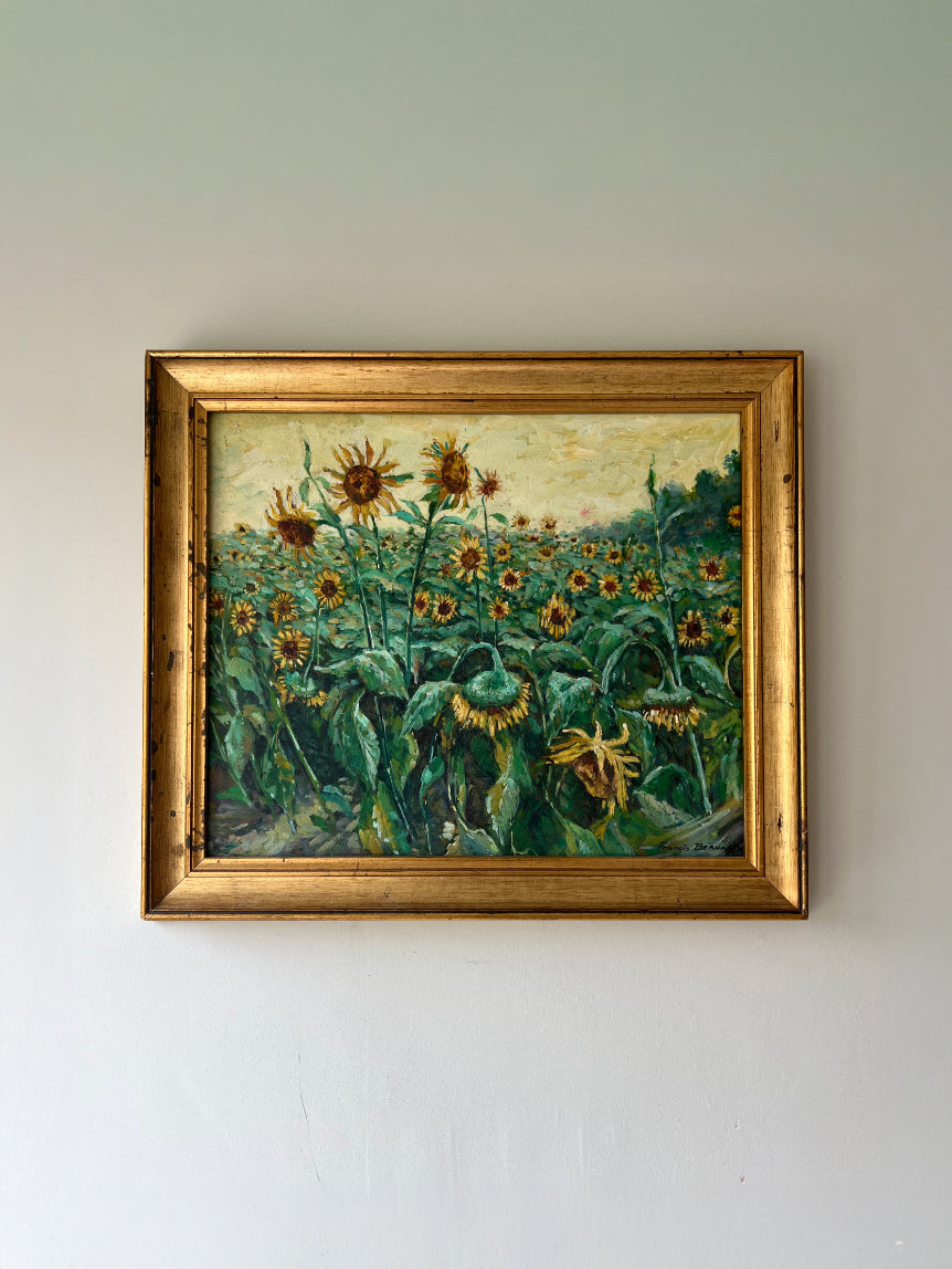 Framed vintage oil painting of sunflowers in an original gilt frame. Available at Hue.