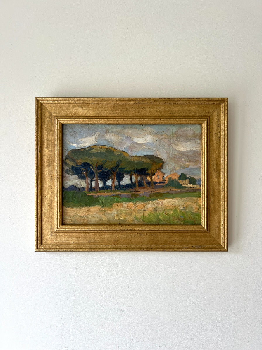 Framed vintage landscape painting of pine trees and a farmhouse. Available at Hue. 
