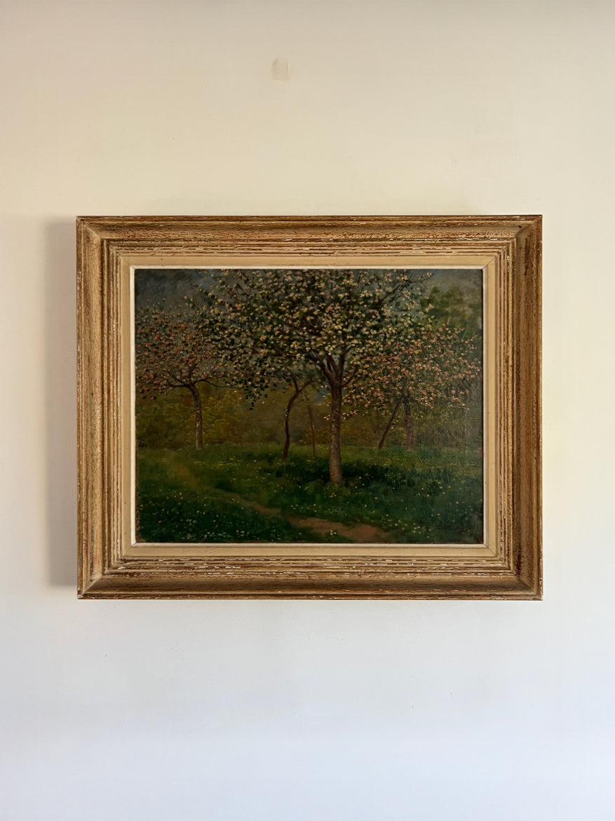 Framed vintage oil painting of a landscape with blossom trees. Available at Hue. 