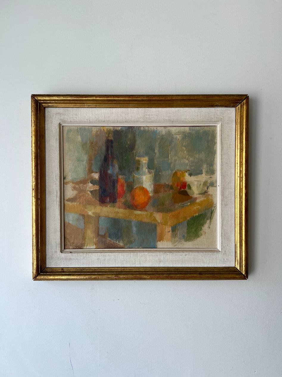 Framed vintage oil painting of a still life scene with bottles and oranges. Available at Hue. 