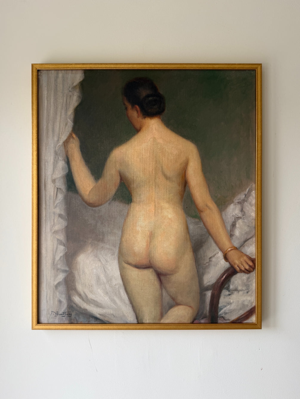 Framed vintage oil painting of a nude woman standing by a bed curtain. Available at Hue. 
