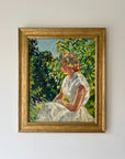 A framed vintage oil painting of a girl seated in dappled light in a garden. Available at Hue. 