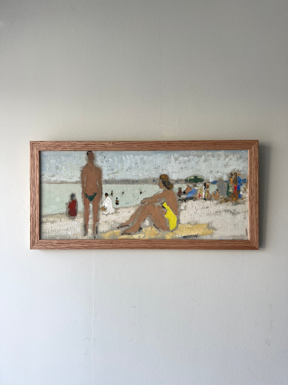 Framed artwork of a beach scene with figures, available at Hue.