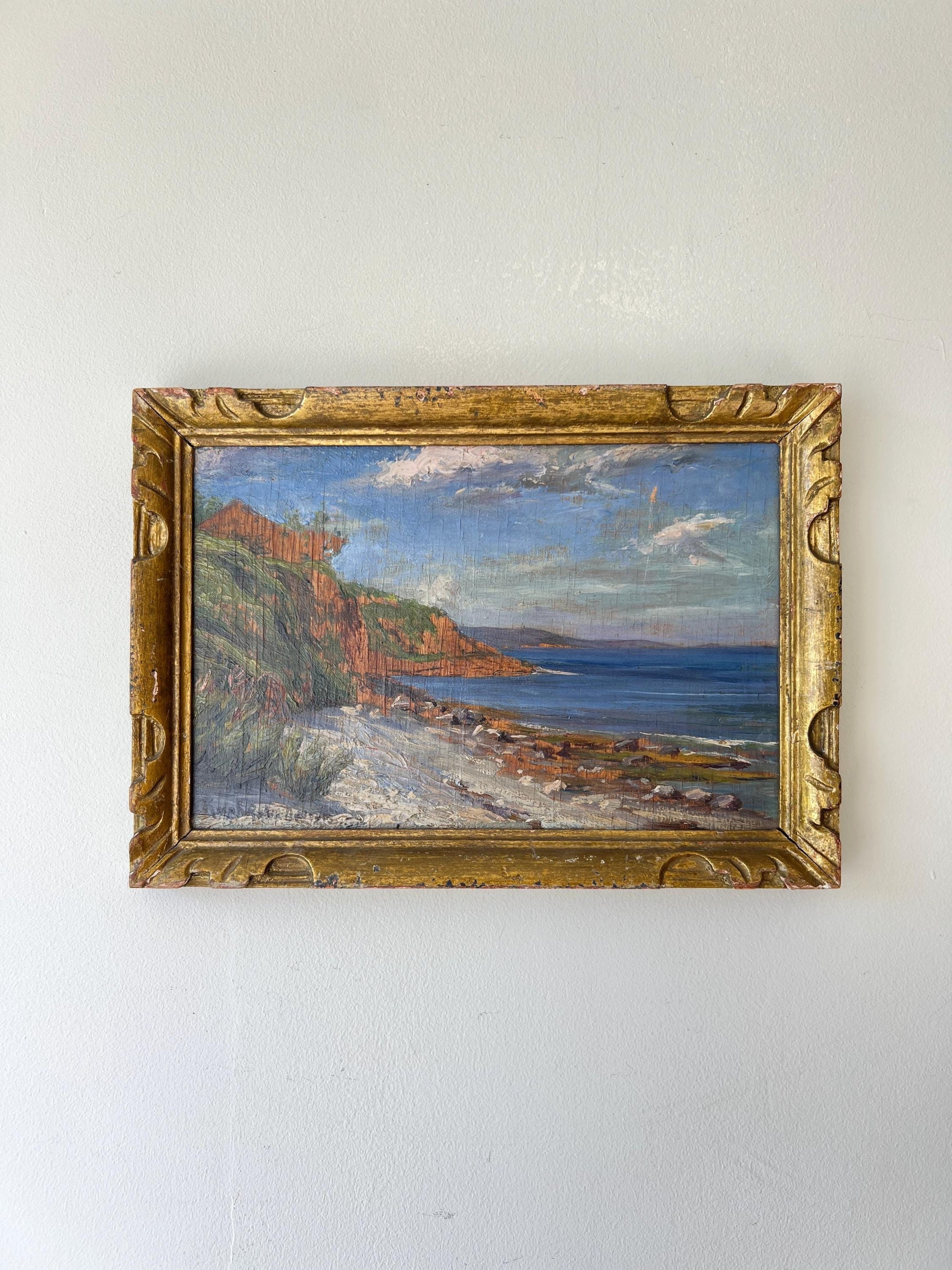 Framed vintage oil painting of a coastal scene in an ornate gilt vintage frame, available at Hue.