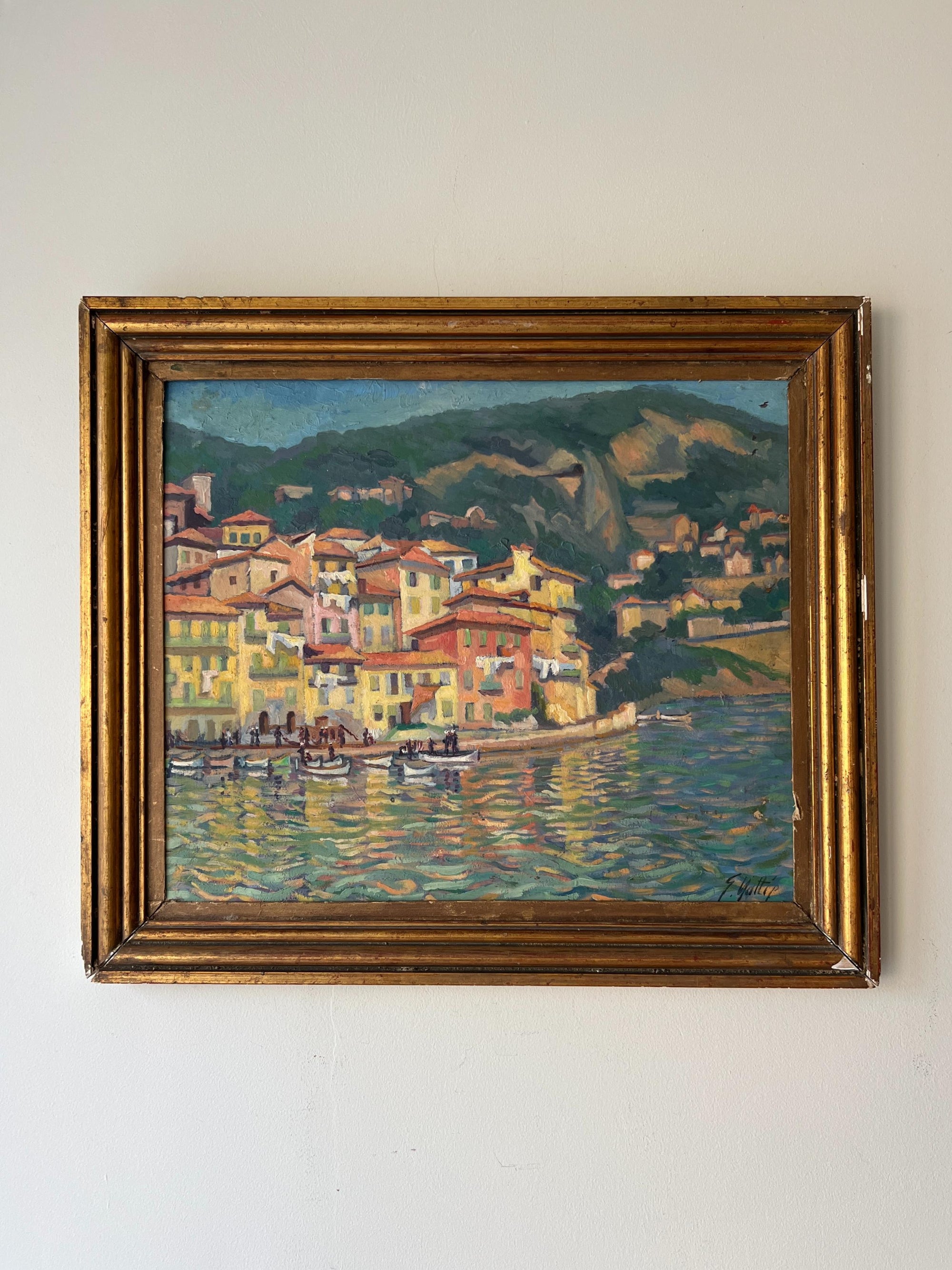 Framed vintage oil painting of a coastal harbour scene with colourful houses and small boats. Available at Hue.