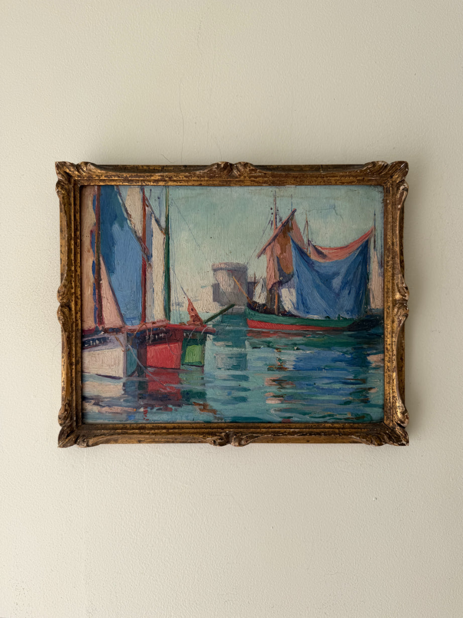 A vintage impressionist-style framed oil painting of sailboats on blue water. Available at Hue.