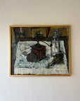 A framed vintage oil painting of a still life scene in a kitchen with artichokes and a coffee grinder. Available at Hue. 