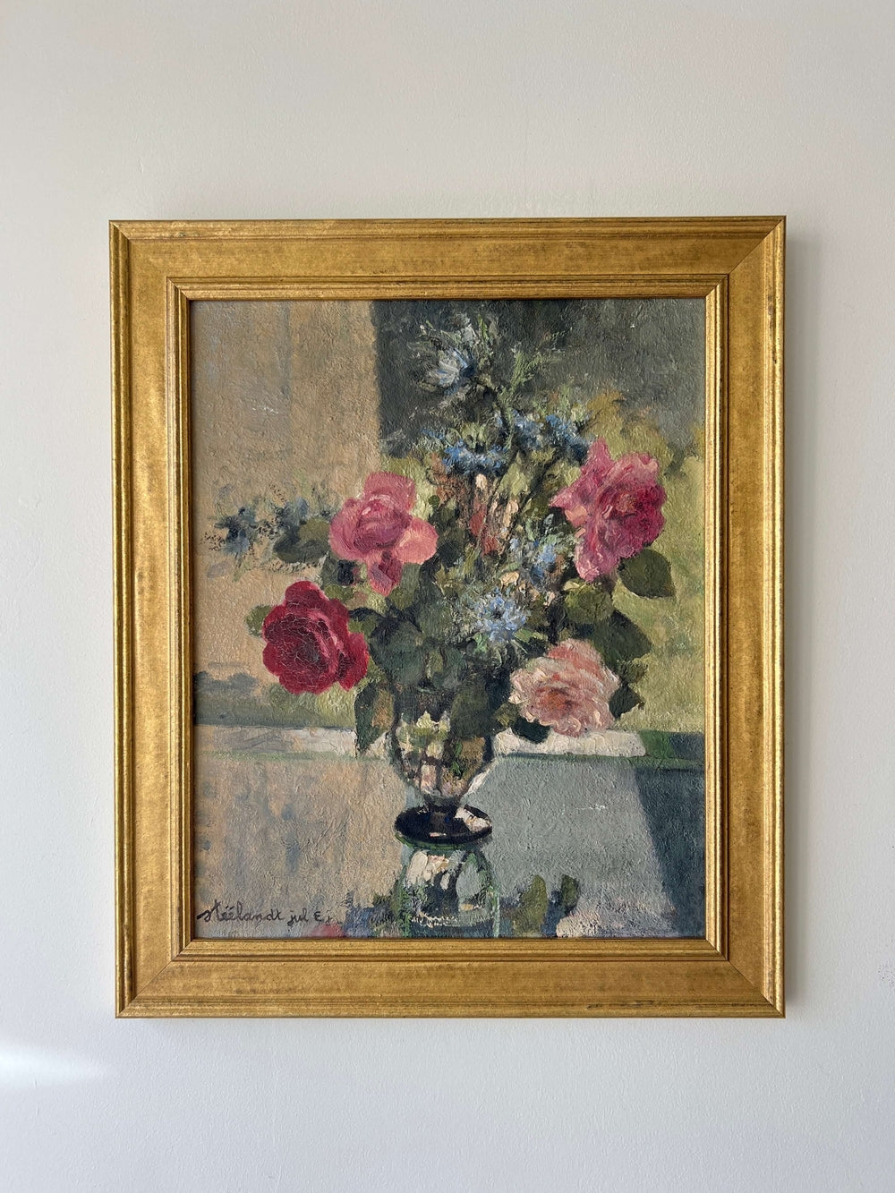 A vintage, framed oil painting of pink and blue florals. Signed by artist, available at Hue.