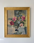 A vintage, framed oil painting of pink and blue florals. Signed by artist, available at Hue.