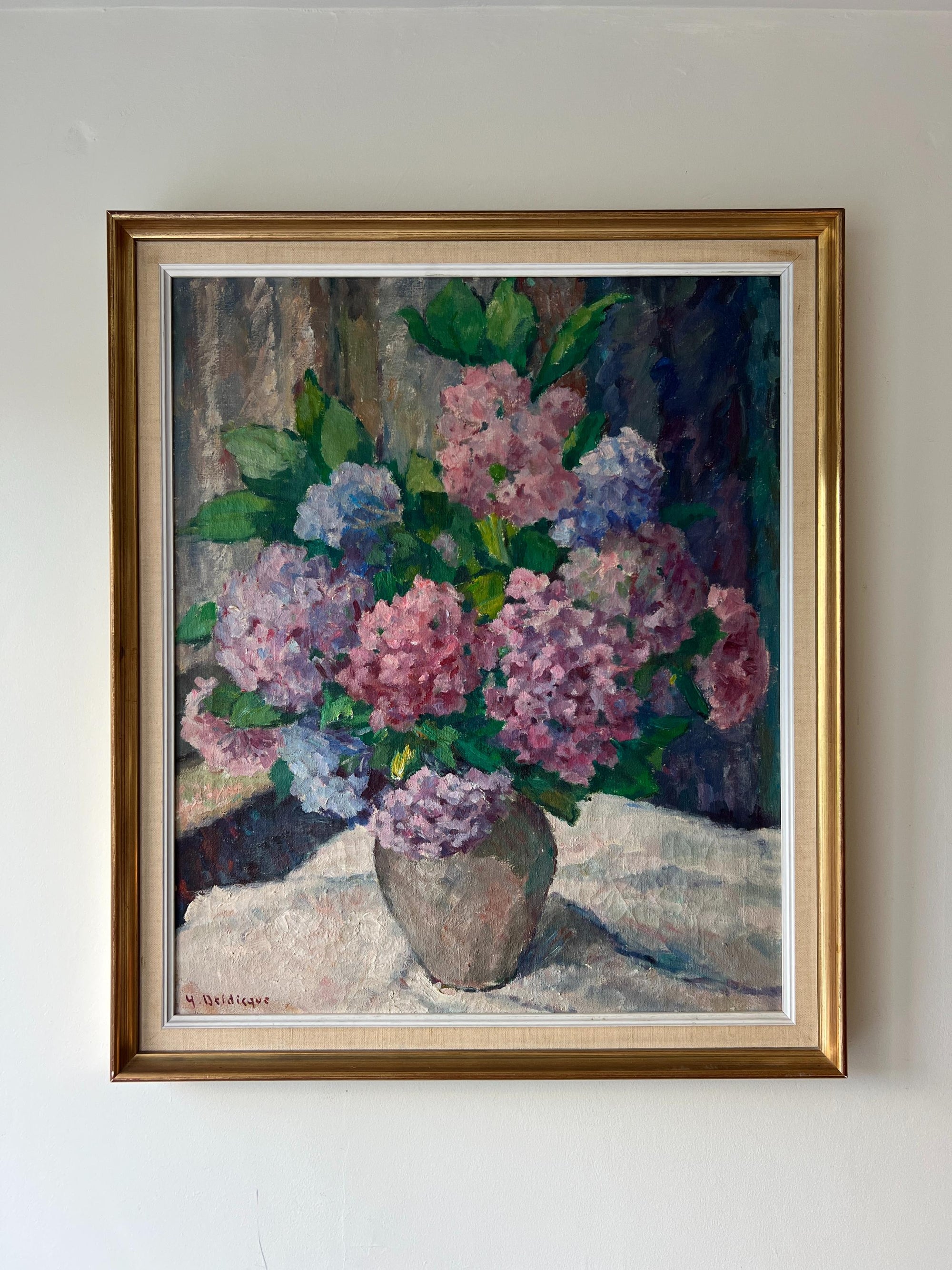 Framed vintage oil painting of a bouquet of flowers. Available at Hue. 