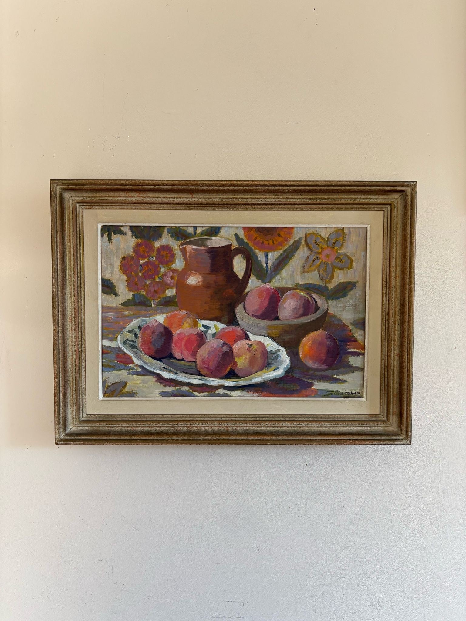 A framed still-life vintage oil painting of a bowl of peaches with a jug. Available at Hue. 