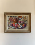 A framed still-life vintage oil painting of a bowl of peaches with a jug. Available at Hue. 