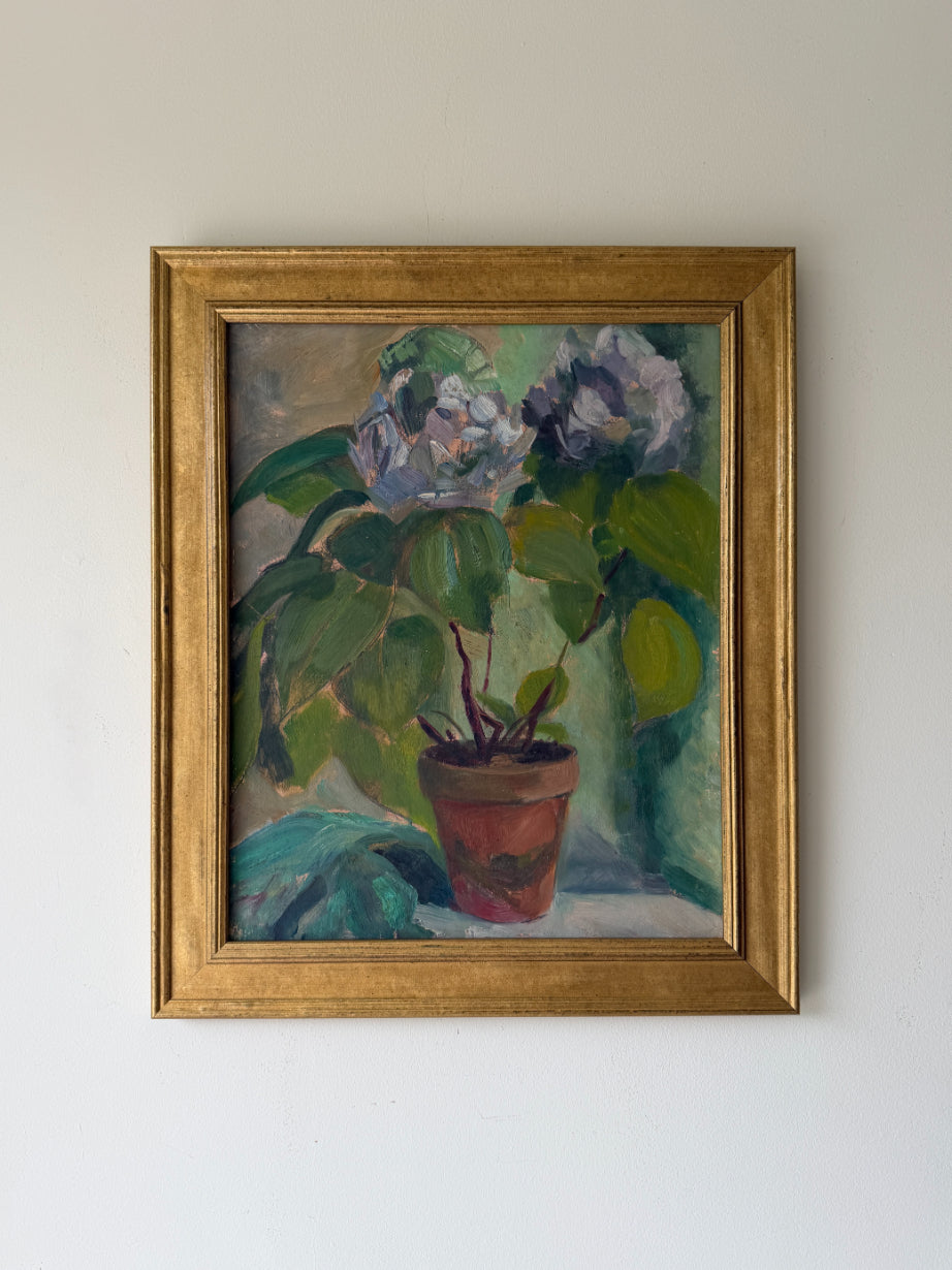 Framed vintage oil painting of pale blue florals in a terracotta pot. Available at Hue.