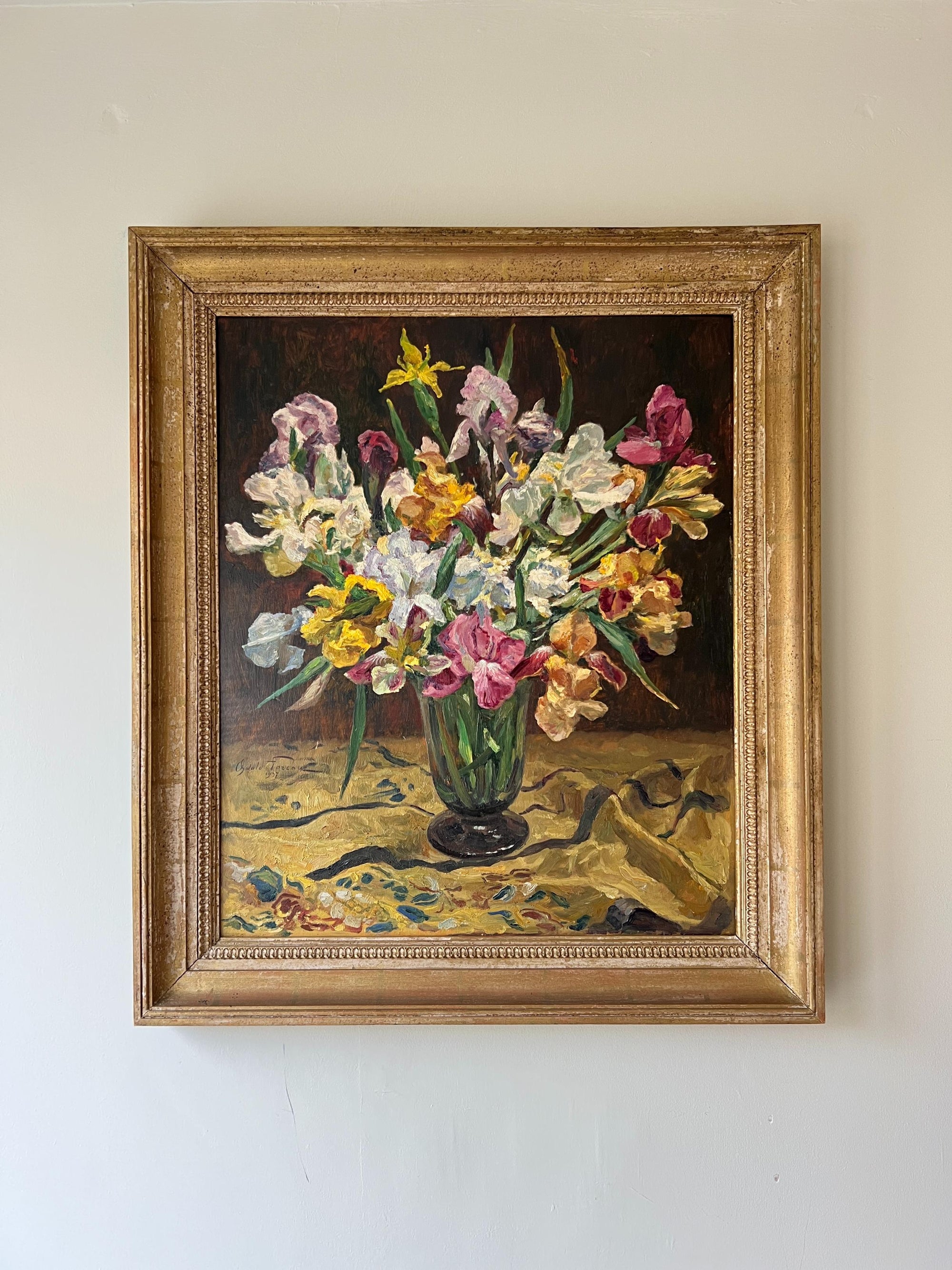 A framed vintage oil painting of a vase of flowers on a dark background. Available at Hue.