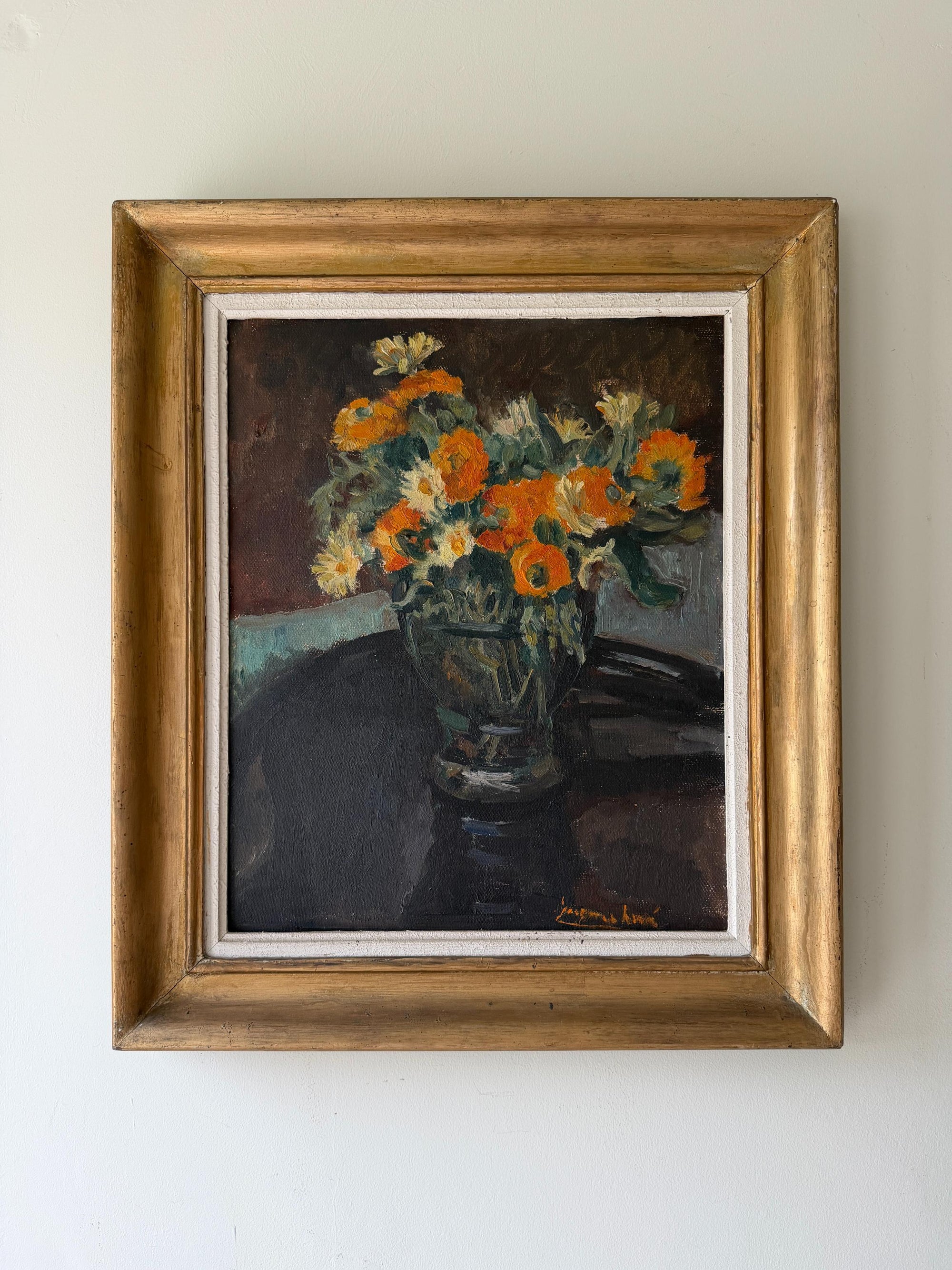 A framed vintage still life oil painting of a vibrant orange and yellow flower bouquet in a vase. Available at Hue. 