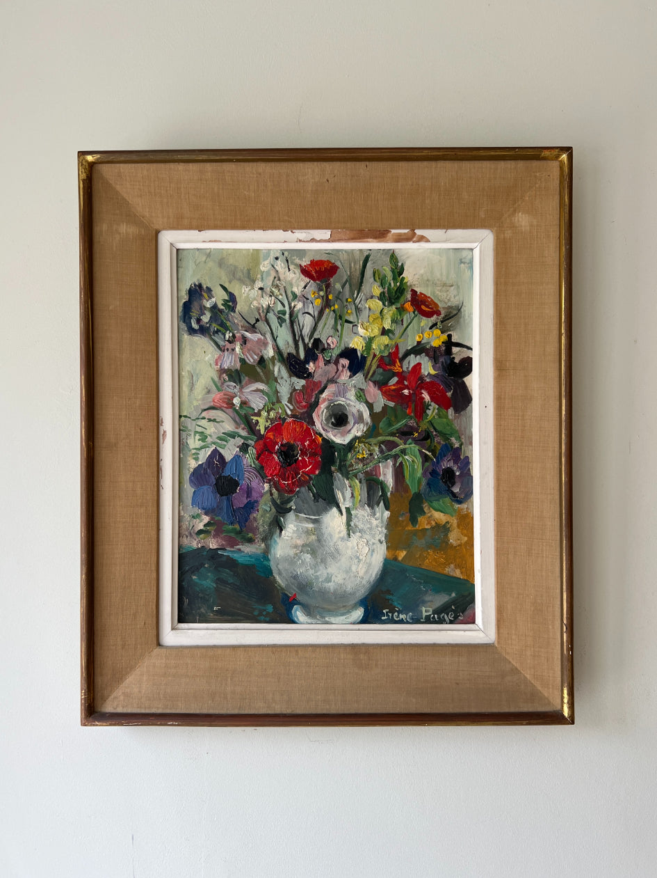 A framed vintage oil painting of a lively, bright bouquet of flowers in reds, blues and yellows. Available at Hue. 