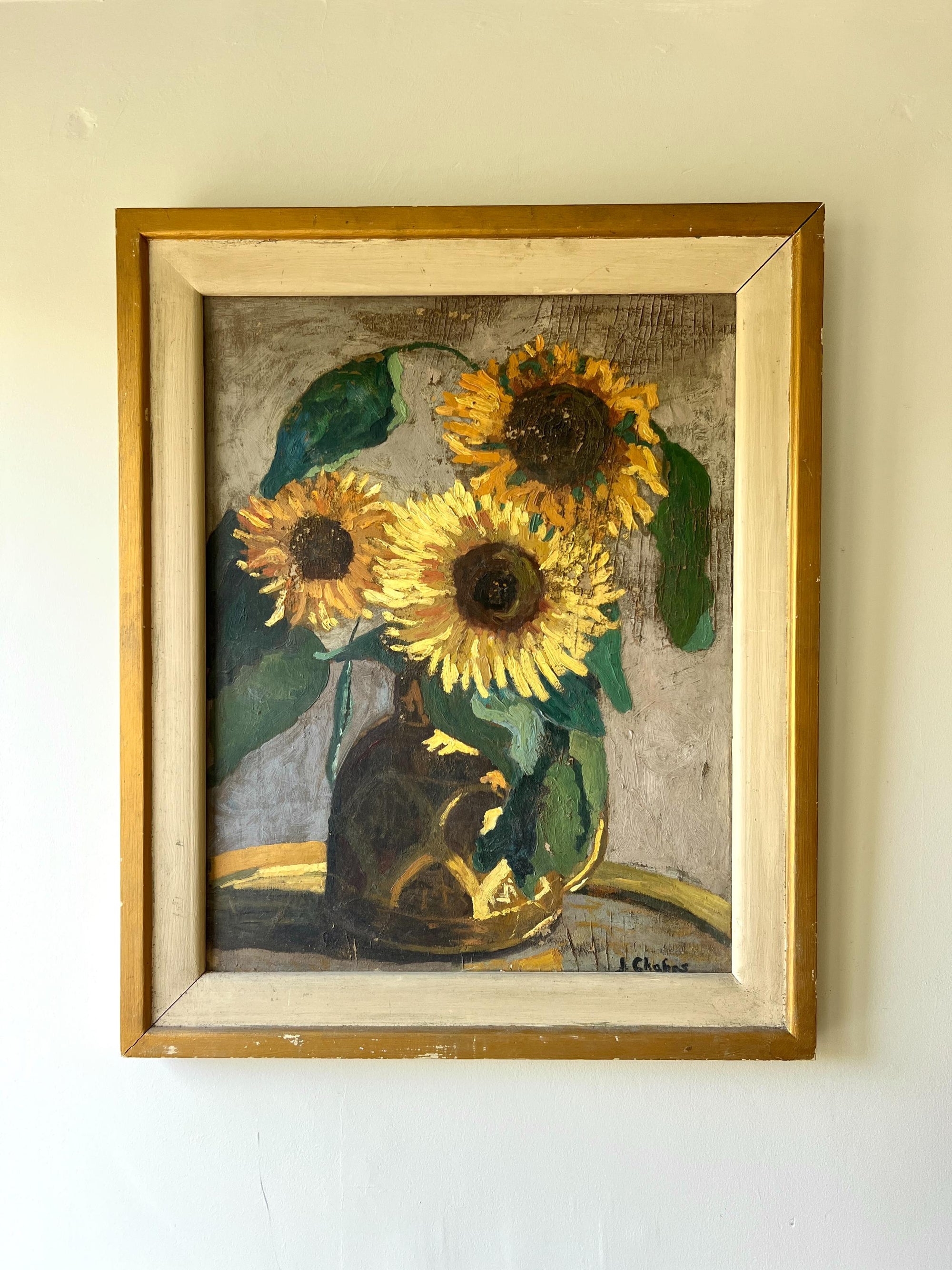 A framed vintage oil painting of a vase of sunflowers in the afternoon light, available at Hue.
