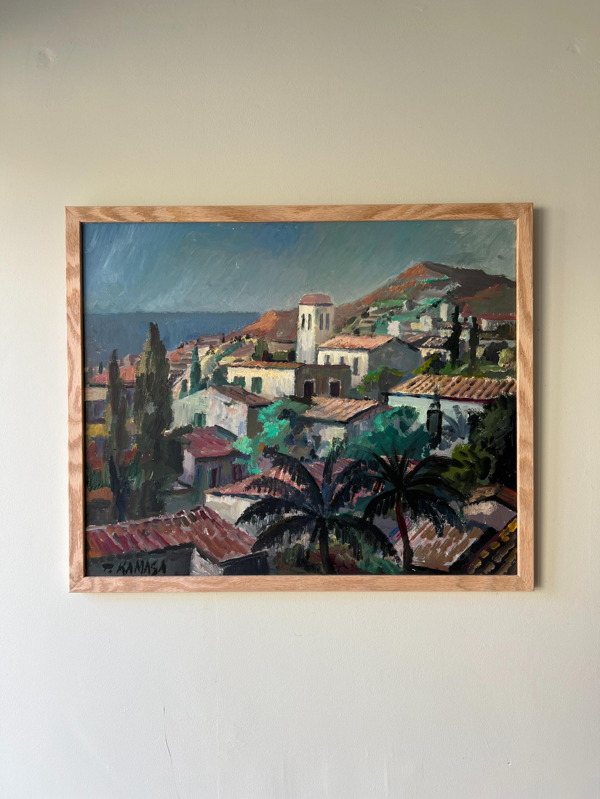Framed vintage oil painting of a coastal village scene, available at Hue.