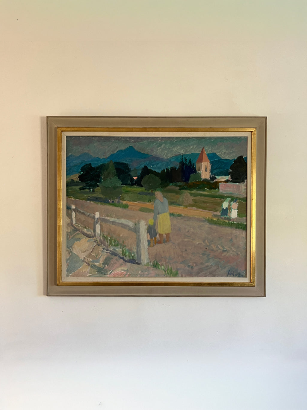 Framed vintage oil painting of a landscape with people, a church and distant mountains. Available at Hue.