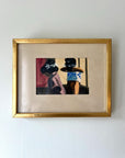 Framed painting of two asian figures with a gold frame on a white wall available from hue