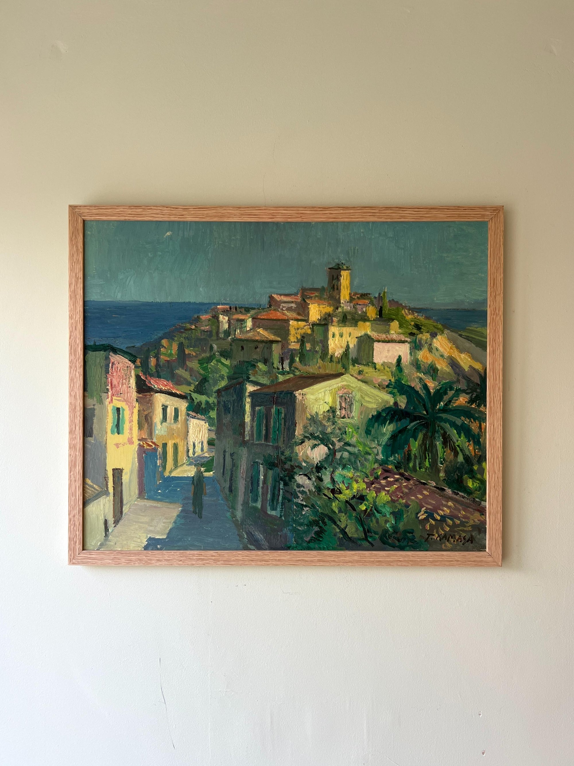 A framed vintage landscape oil painting of a southern European hillside village in the sunlight Available at Hue.
