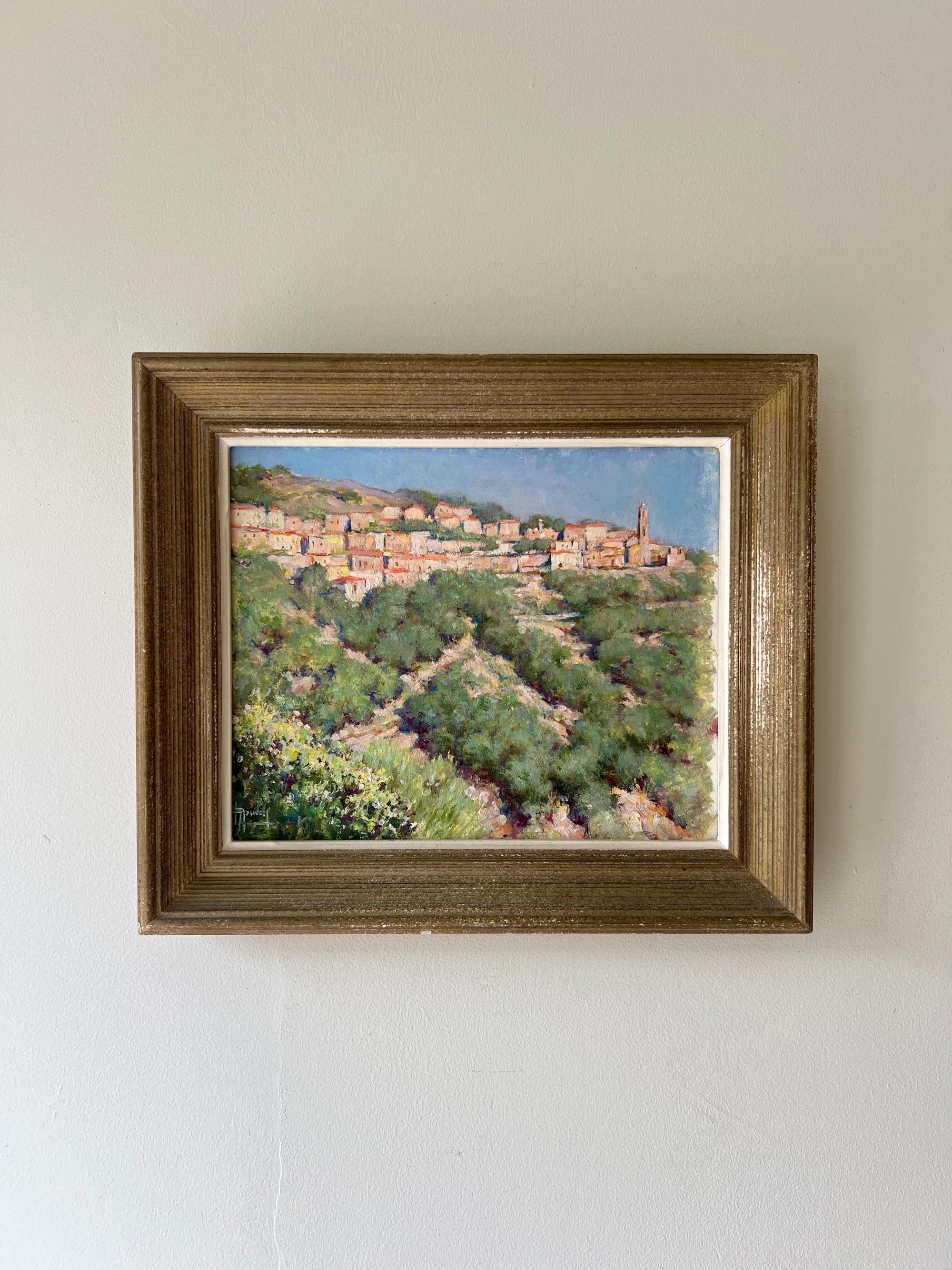 Framed vintage oil painting of a hillside village in Corsica, available at Hue.