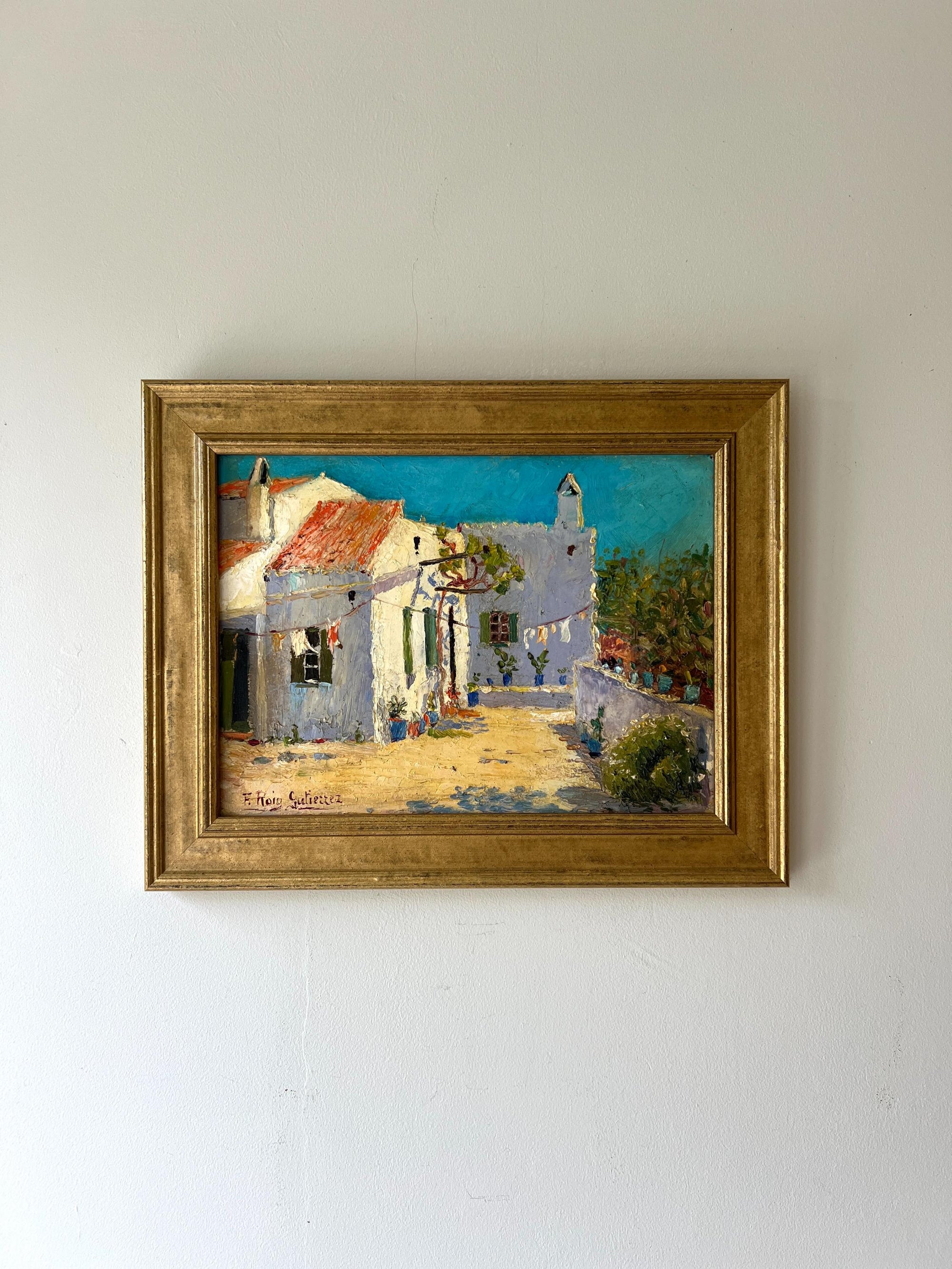 A framed vintage oil painting of a rural spanish villa in the sunshine. Available at Hue. 