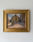 A framed vintage impressionist oil painting of a European street scene with yellow and ochre buildings. Available at Hue.