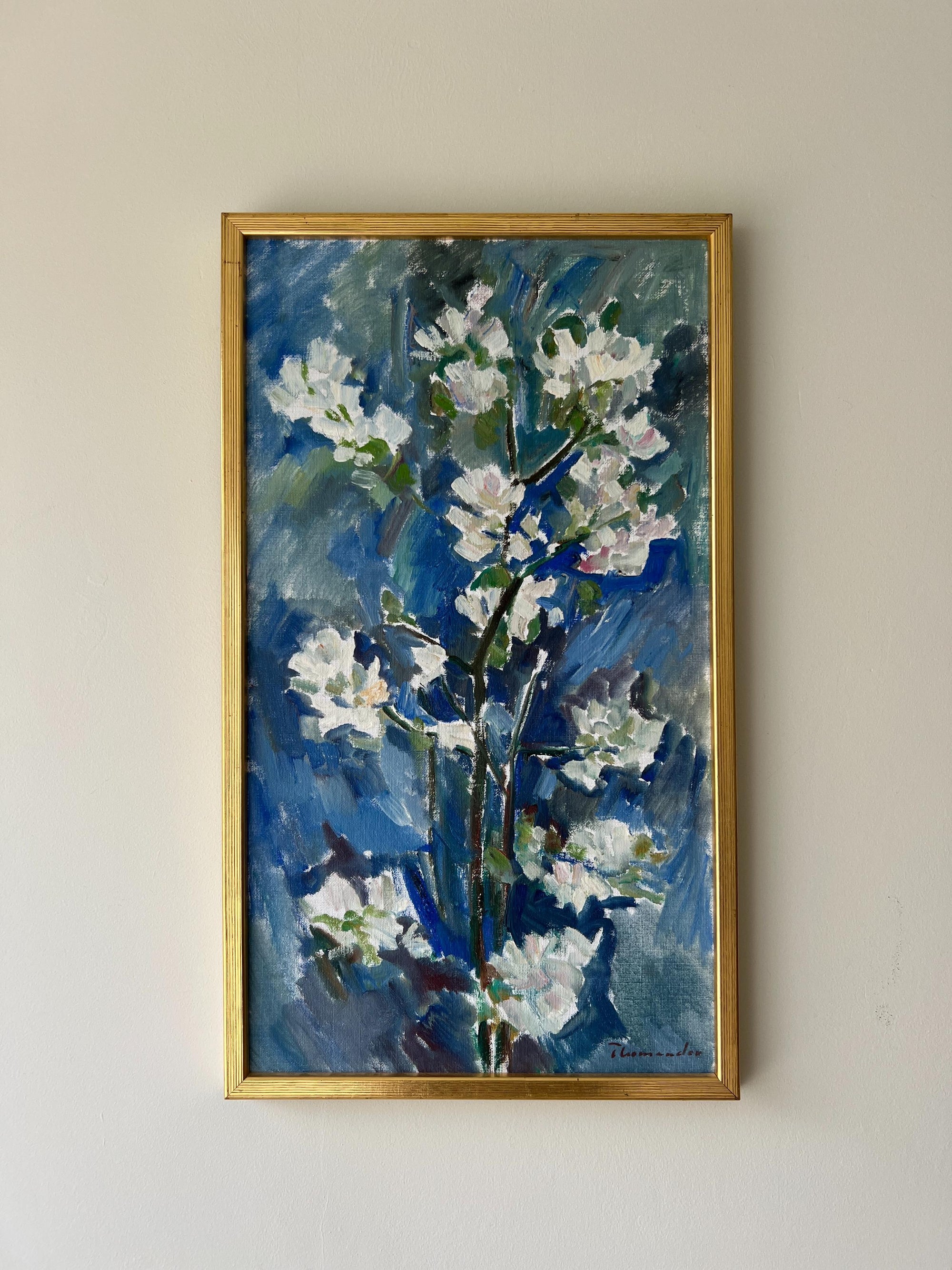Framed vintage oil painting of white apple blossom flowers on a blue background framed in a vintage gilt frame, available at Hue.