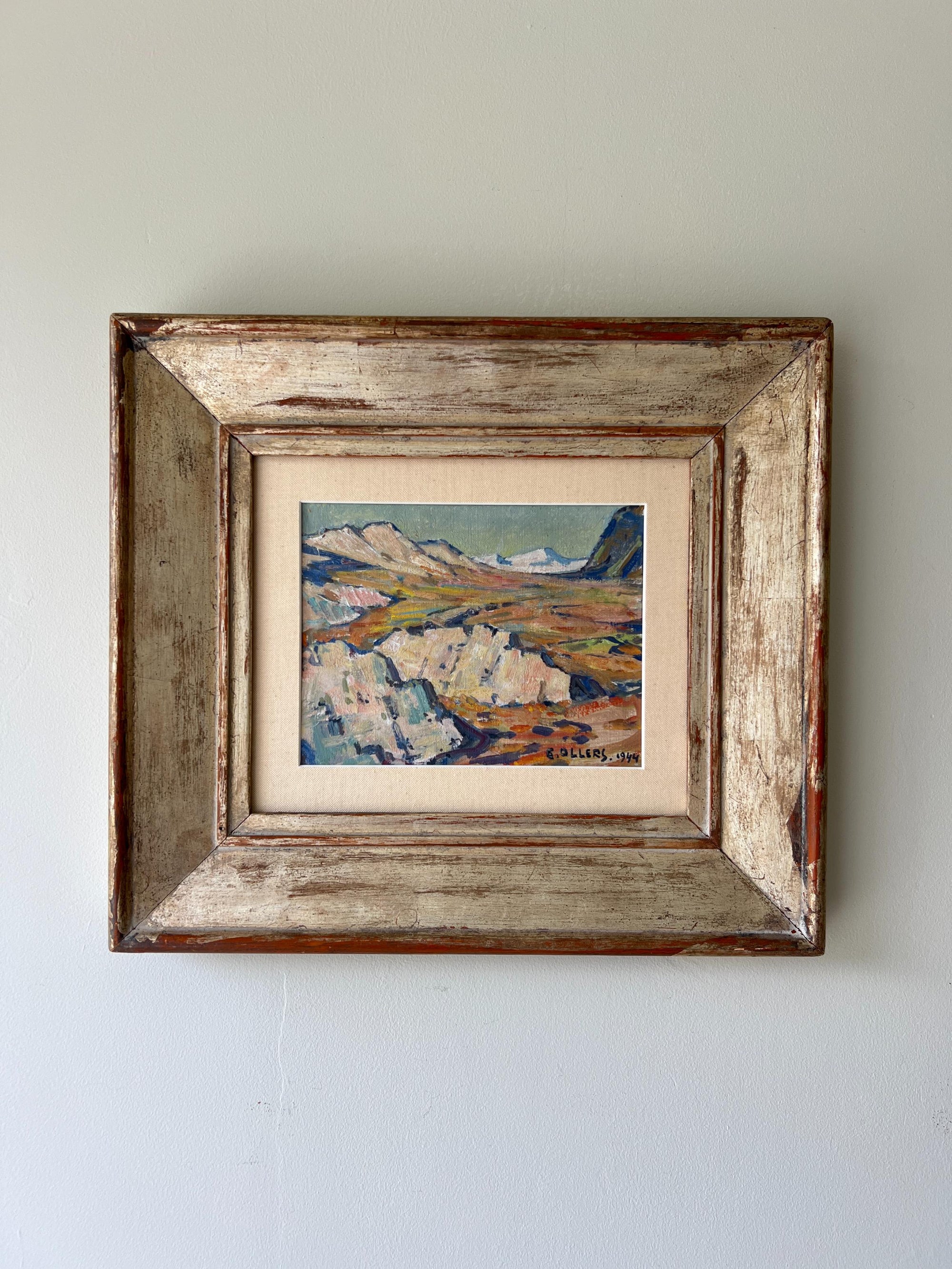 A framed vintage oil painting of a mountainous landscape in a vintage frame, available at Hue.