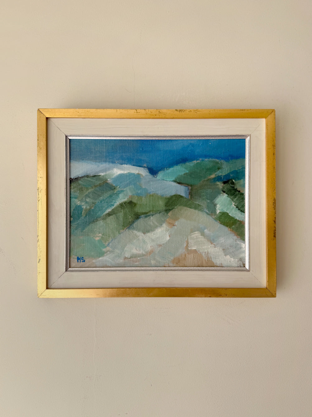 Framed vintage oil painting of a landscape with a gold frame. Available at Hue. 