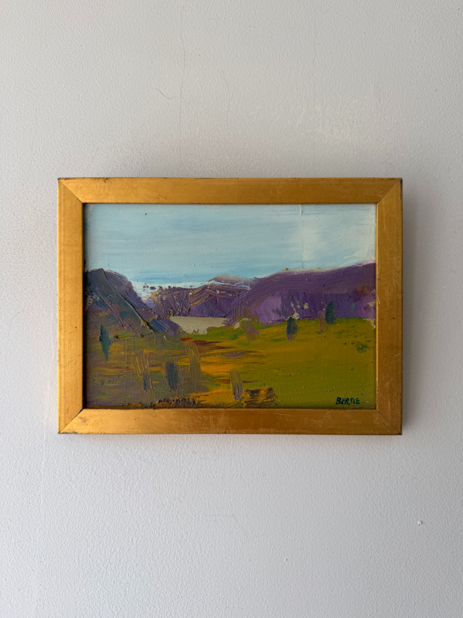 Small framed vintage oil painting of a landscape with mountains and fields. Available at Hue. 