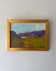 Small framed vintage oil painting of a landscape with mountains and fields. Available at Hue. 